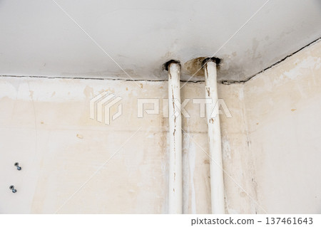 corner of room with shabby walls, heating pipes corner of room with shabby walls, heating pipes 137461643