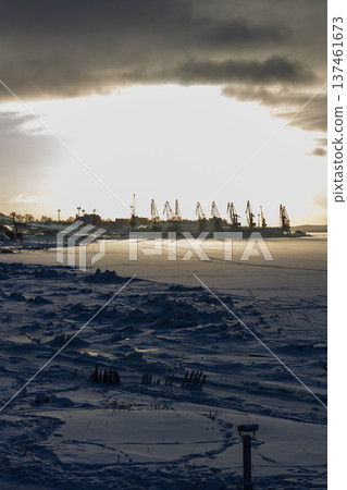 snowy sea shore and port crane in Kandalaksha town snowy sea shore and port crane in Kandalaksha town 137461673