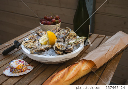 Fresh Raw Oysters with Citron, Baguette, Butter, and Cider Fresh Raw Oysters with Citron, Baguette, Butter, and Cider 137462424