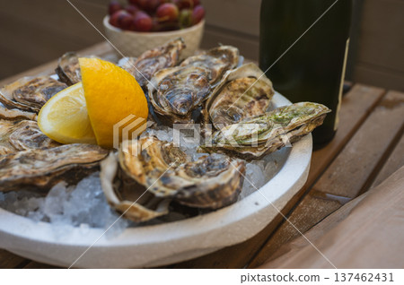 Fresh Raw Oysters with Citron, Baguette, Butter, and Cider Fresh Raw Oysters with Citron, Baguette, Butter, and Cider 137462431