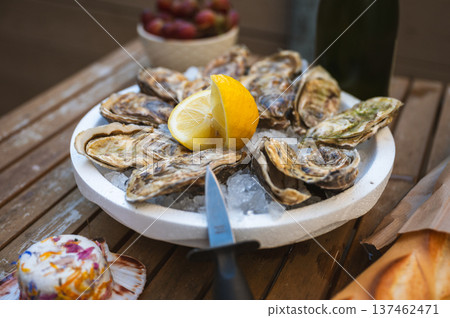 Fresh Raw Oysters with Citron, Baguette, Butter, and Cider 137462471