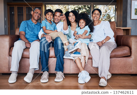 Portrait, watching tv and smile with big family on sofa for streaming, movie or relax. Love, generations and grandparents with parents and children in living room at home for subscription and embrace 137462611