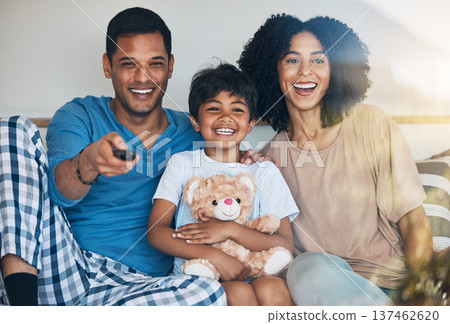 Happy, morning and a family watching tv on bed in their home together for streaming or entertainment. Parents, children or funny boy in the bedroom with his mom and dad to enjoy a television movie Happy, morning and a family watching tv on bed in their home together for streaming or entertainment. Parents, children or funny boy in the bedroom with his mom and dad to enjoy a television movie 137462620