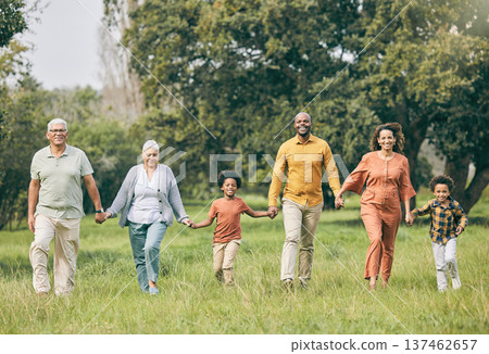 Portrait, holding hands and happy family at a park walking, bond and having fun in nature together. Love, smile and children with parents, grandparents and freedom, support and trust on forest walk Portrait, holding hands and happy family at a park walking, bond and having fun in nature together. Love, smile and children with parents, grandparents and freedom, support and trust on forest walk 137462657