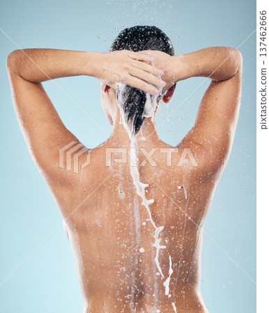 Hair care, shampoo or woman washing in shower for wellness or healthy head on blue background. Cosmetics, beauty model or back of wet person washing or grooming for natural hygiene to relax in studio 137462666