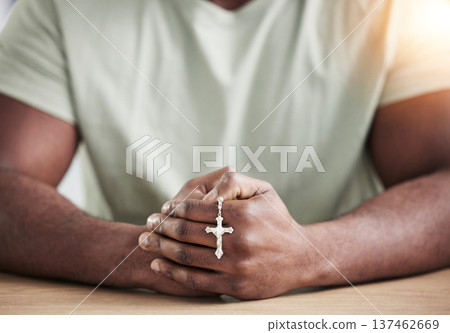 Crucifix cross, man hands and prayer beads in home with faith, christian praise and religion. Praying, necklace and worship in house with hope, gratitude and spiritual guide for support and healing 137462669
