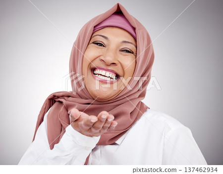Muslim woman, portrait and blowing a kiss in studio with happiness, kindness or positive attitude. Hijab, islam and fashion of a mature person on grey background for beauty, cosmetics or flirting 137462934