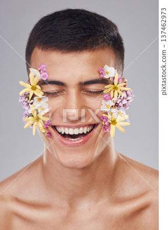 Skincare, man and flowers on face in studio, eyes closed and natural cosmetics for art, makeup product and wellness. Spring, person and closeup of floral decoration for facial on gray background Skincare, man and flowers on face in studio, eyes closed and natural cosmetics for art, makeup product and wellness. Spring, person and closeup of floral decoration for facial on gray background 137462973