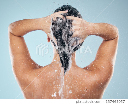 Shower, shampoo or woman cleaning hair for wellness or healthy head in studio on blue background. Cosmetics, beauty model or back of wet person washing or grooming for natural hygiene to relax Shower, shampoo or woman cleaning hair for wellness or healthy head in studio on blue background. Cosmetics, beauty model or back of wet person washing or grooming for natural hygiene to relax 137463057
