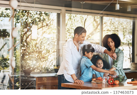 Parents, kids and cooking with vegetables, kitchen and helping hand for learning, nutrition and food in home. Father, mother and children with vegan meal prep, teaching and health in family house 137463073
