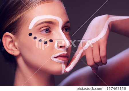 Woman, beauty and paint in studio, face and thikning for art, wellness and fantasy with cosmetics by dark background. Girl, model and facial painting with ideas, creativity and pattern with makeup Woman, beauty and paint in studio, face and thikning for art, wellness and fantasy with cosmetics by dark background. Girl, model and facial painting with ideas, creativity and pattern with makeup 137463156
