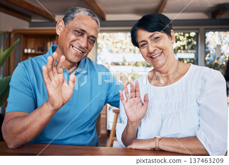 Video call, wave and portrait of senior couple with communication in the dining room at home. Happy, smile and elderly man and woman in retirement greeting for an online virtual conversation together Video call, wave and portrait of senior couple with communication in the dining room at home. Happy, smile and elderly man and woman in retirement greeting for an online virtual conversation together 137463209