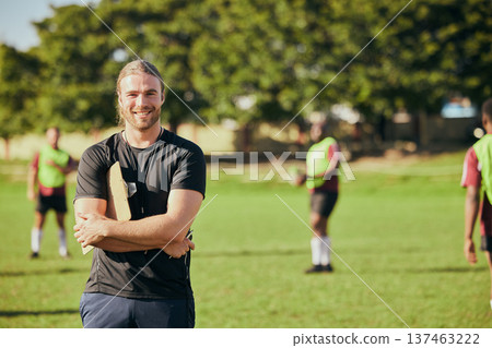 Portrait, fitness and a rugby coach on a field with his team training or getting ready for match competition. Exercise, sports and strategy with a happy male trainer on grass for practice workout 137463222