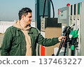 A man fills his car with gas during the fuel crisis 137463227