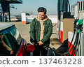 A man fills his car with gas during the fuel crisis 137463228