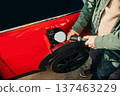 A man fills his car with gas during the fuel crisis 137463229