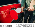A man fills his car with gas during the fuel crisis 137463231