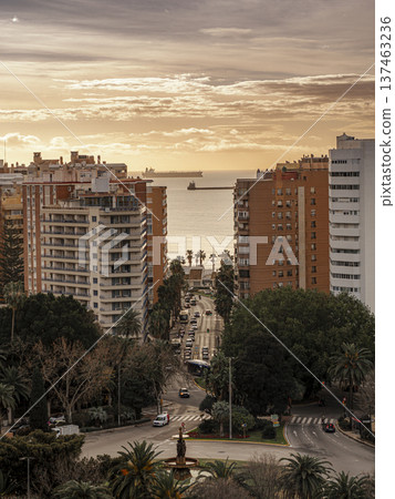Coastal City Sunset Skyline With Apartments, Palm Trees and Busy Street Leading to the Sea Coastal City Sunset Skyline With Apartments, Palm Trees and Busy Street Leading to the Sea 137463236