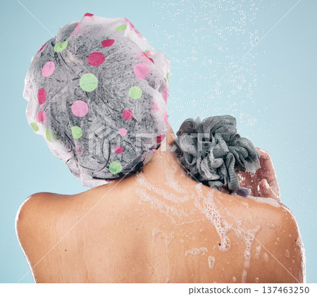 Person, shower and back in water drops for hygiene, grooming or washing against a blue studio background. Rear view of model in soapy body wash, cleaning or skincare routine under rain in bathroom Person, shower and back in water drops for hygiene, grooming or washing against a blue studio background. Rear view of model in soapy body wash, cleaning or skincare routine under rain in bathroom 137463250