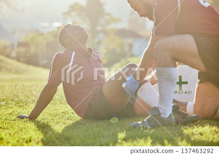 Football, medic and man with injury, field and pain with bruise, broken and inflammation with sunshine. Person, player and medical professional with equipment, fitness and match with emergency Football, medic and man with injury, field and pain with bruise, broken and inflammation with sunshine. Person, player and medical professional with equipment, fitness and match with emergency 137463292