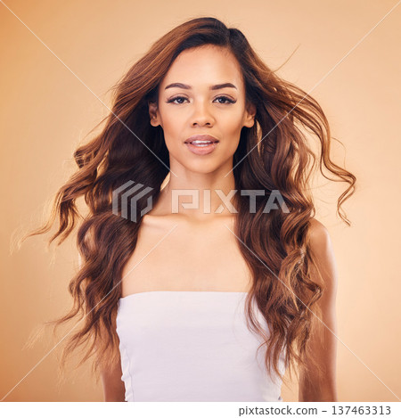 Portrait, woman and curly hair for beauty in studio isolated on a brown background. Long face, wavy hairstyle and natural cosmetics of model in salon treatment for health, wellness or hairdresser Portrait, woman and curly hair for beauty in studio isolated on a brown background. Long face, wavy hairstyle and natural cosmetics of model in salon treatment for health, wellness or hairdresser 137463313