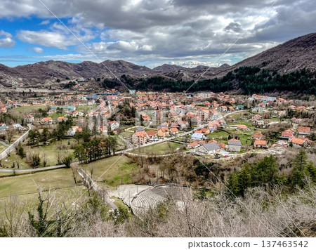 Idyllic mountain village featuring rocky valley and vibrant rooftops Idyllic mountain village featuring rocky valley and vibrant rooftops 137463542