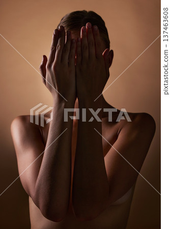Woman, body and hands covering face on dark brown background in studio for creative aesthetic, art deco and skin texture. Shy person, model and hide in shadow for nude beauty, wellness and sensuality Woman, body and hands covering face on dark brown background in studio for creative aesthetic, art deco and skin texture. Shy person, model and hide in shadow for nude beauty, wellness and sensuality 137463608