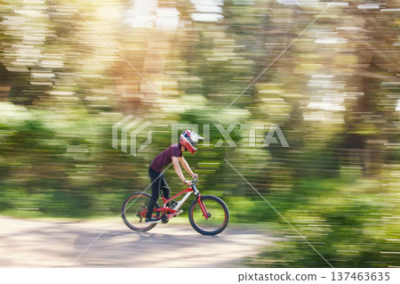 Blurred trees, sports and athlete cycling on bicycle for race, competition or marathon training. Fitness, fast and man cyclist riding a bike for speed practice challenge in mountain forest in nature. 137463635