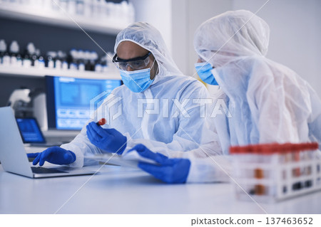 Laptop, science and blood sample with a research team in a laboratory for research or innovation. Computer, teamwork and dna in a glass vial for lab test or study as a pathology scientist colleagues 137463652