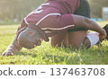 Sports, field injury and a black man during soccer with an emergency in fitness or training. Grass, pain and an African football player or athlete on the ground during a game with an accident 137463708