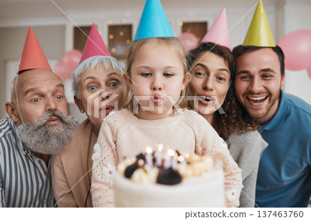 Birthday cake, candles and big family celebrate in a home party, event and happiness on face in a house together. Mother, father and grandparents excited for surprise gathering with children or kids Birthday cake, candles and big family celebrate in a home party, event and happiness on face in a house together. Mother, father and grandparents excited for surprise gathering with children or kids 137463760