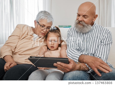 Relax, kid or grandparents with tablet for elearning or studying for education or remote learning at home. Family, grandfather or grandmother with girl reading ebook or streaming videos or movies 137463808