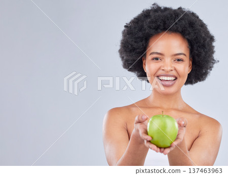 Apple, black woman and portrait with health, diet and natural skincare glow in studio. Happy, face and fruit for healthy nutrition, grey background and mockup space with a smile from organic food Apple, black woman and portrait with health, diet and natural skincare glow in studio. Happy, face and fruit for healthy nutrition, grey background and mockup space with a smile from organic food 137463963