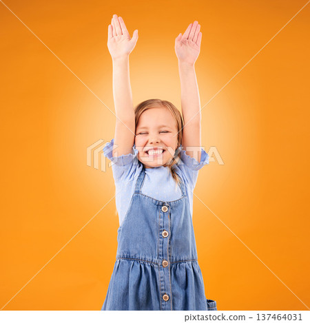 Excited, celebration and girl child with arms up in studio for success, winner or happy on orange background. Yes, news and kid with hands, smile and celebrating achievement, victory or announcement Excited, celebration and girl child with arms up in studio for success, winner or happy on orange background. Yes, news and kid with hands, smile and celebrating achievement, victory or announcement 137464031