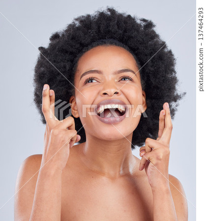 Hope, luck and black woman with fingers crossed for beauty and skincare isolated in a studio gray background with smile. Notification, deal and young person excited for cosmetics with optimism Hope, luck and black woman with fingers crossed for beauty and skincare isolated in a studio gray background with smile. Notification, deal and young person excited for cosmetics with optimism 137464293
