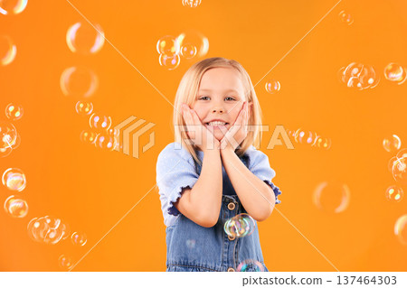 Girl child, face and bubbles, playing and fun with youth isolated on orange background. Liquid soap, happy and portrait with young kid from Australia in studio, playful and toys with childhood Girl child, face and bubbles, playing and fun with youth isolated on orange background. Liquid soap, happy and portrait with young kid from Australia in studio, playful and toys with childhood 137464303