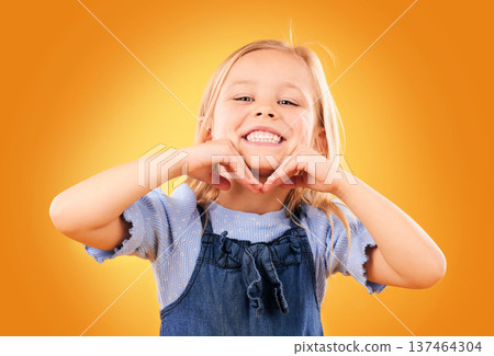Happy, smile and portrait of child on orange background with happiness, joy and excited in studio. Fashion, childhood and hands on face of girl in fun or trendy outfit, young style and summer clothes Happy, smile and portrait of child on orange background with happiness, joy and excited in studio. Fashion, childhood and hands on face of girl in fun or trendy outfit, young style and summer clothes 137464304