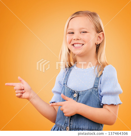 Happy, portrait and child with finger gun in studio for advertising announcement or promotion. Young girl kid on orange background for pointing or hand sign for direction, attention or excited smile Happy, portrait and child with finger gun in studio for advertising announcement or promotion. Young girl kid on orange background for pointing or hand sign for direction, attention or excited smile 137464306