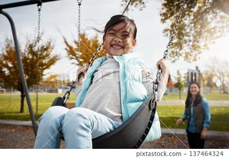 Happy, mother or daughter in park on swing, having fun or bonding on winter break. Smile, playful and Asian people on playground with portrait, connection or emotional development on weekend together Happy, mother or daughter in park on swing, having fun or bonding on winter break. Smile, playful and Asian people on playground with portrait, connection or emotional development on weekend together 137464324
