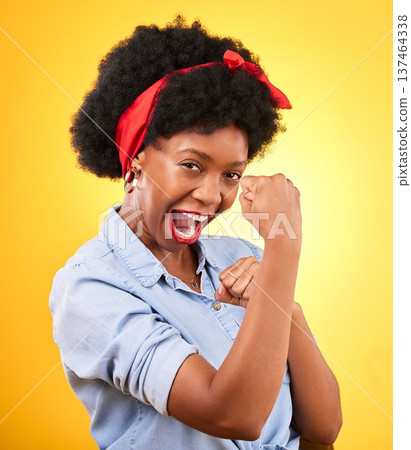 Muscle, flex and success with portrait of black woman in studio for power, motivation and energy. Empowerment, pride and champion with person and fist on yellow background for challenge and hard work 137464338