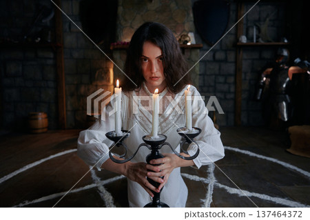 Gothic priestess in ritual, woman performing mystical summoning spell 137464372