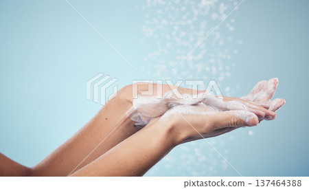 Cleaning, hands and woman with soap and water in studio, blue background and healthcare or skincare mockup. Model, closeup or washing skin for clean, hygiene and protection from bacteria or virus Cleaning, hands and woman with soap and water in studio, blue background and healthcare or skincare mockup. Model, closeup or washing skin for clean, hygiene and protection from bacteria or virus 137464388