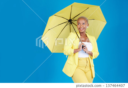 Black woman, umbrella and face with smile in studio for life insurance and security isolated on blue background. Shield, happiness and person for fashion, style and confidence with mockup space 137464407