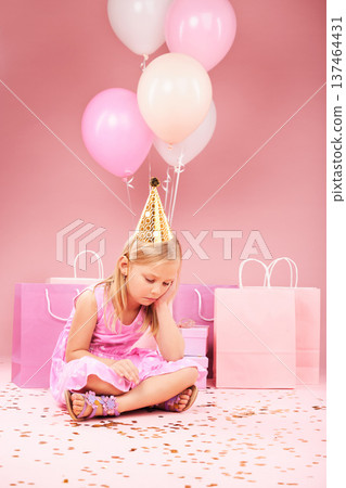 Depression, sad birthday and girl on pink background for party, celebration and festive event in studio. Upset, emotion and unhappy, lonely and young child on floor with balloons, presents and gifts Depression, sad birthday and girl on pink background for party, celebration and festive event in studio. Upset, emotion and unhappy, lonely and young child on floor with balloons, presents and gifts 137464431