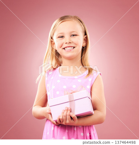 Child, gift or present portrait in studio for birthday, holiday or happy celebration. Excited girl kid on a pink background with box for surprise, giveaway prize or celebrate win with smile 137464498