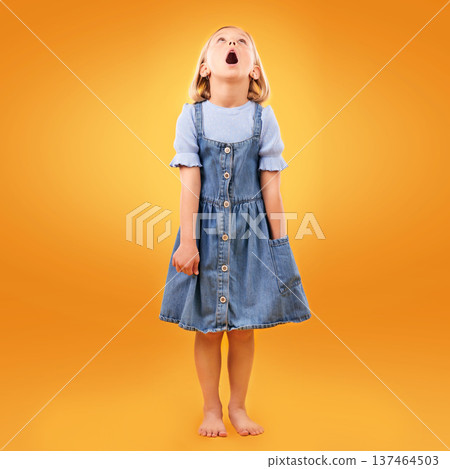 Fashion, wow and girl child in studio for news, omg or coming soon promotion on orange background. Looking up, surprise and kid shocked by choice, sale or discount, announcement or prize giveaway Fashion, wow and girl child in studio for news, omg or coming soon promotion on orange background. Looking up, surprise and kid shocked by choice, sale or discount, announcement or prize giveaway 137464503