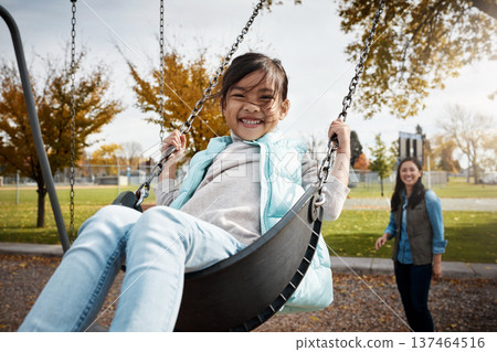 Asian family, portrait and swing with girl child outdoor for having fun or mother bonding. Afternoon, playful or smile of excited daughter and single parent woman in park together for autumn break 137464516