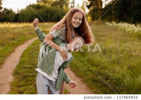Young Siblings Sprinting Happily Together. Elder Sister And Younger Brother Share Joyful Run Young Siblings Sprinting Happily Together. Elder Sister And Younger Brother Share Joyful Run 137464958