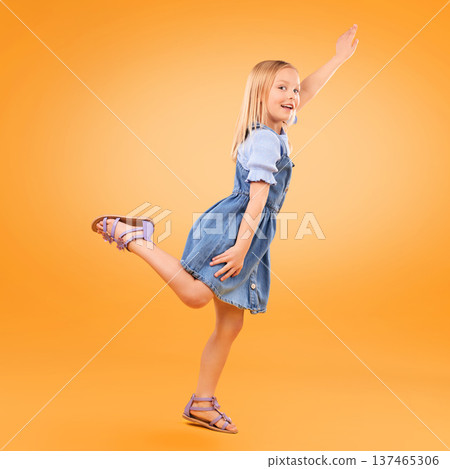 Portrait, girl and kid with a smile, fly or fantasy with joy, happiness or excited on a yellow studio background. Person, model or child with power, hero game or imagine with energy, happy or playful 137465306