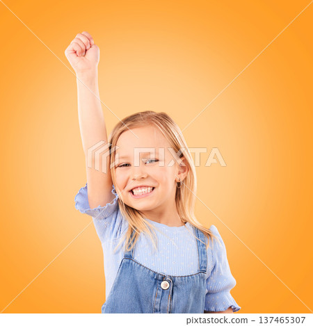Hand up, portrait and girl child in studio happy, excited and celebrating success on orange background space. Face, smile and kid winner with victory fist for good news, promotion or prize giveaway Hand up, portrait and girl child in studio happy, excited and celebrating success on orange background space. Face, smile and kid winner with victory fist for good news, promotion or prize giveaway 137465307